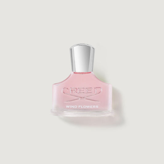 windflowers bottle with glass stopper showing pink liquid in a curved bottle